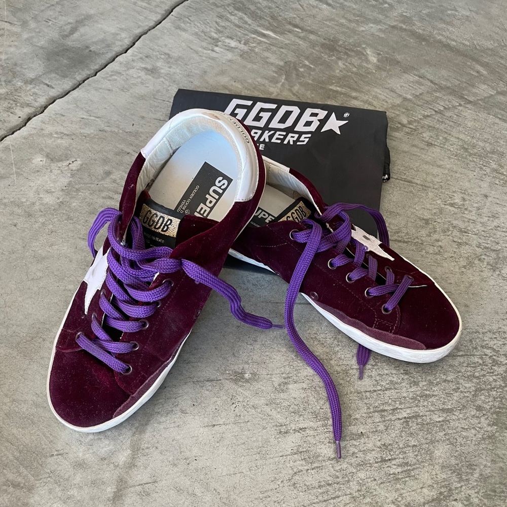 Golden Goose burgundy velvet Super Star sneakers.